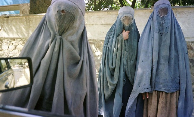 an afghan woman clad in burqa veil begs while two wait saturday october in kabul the