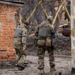 98375657 Ukrainian soldier patrol in the village of Malaya Rohan east of Kharkiv on March 30 2022
