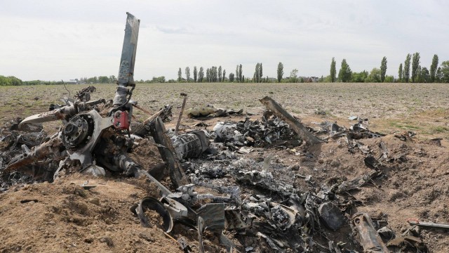 99200980 a destroyed russian military helicopter is seen near the town of makariv as russias at