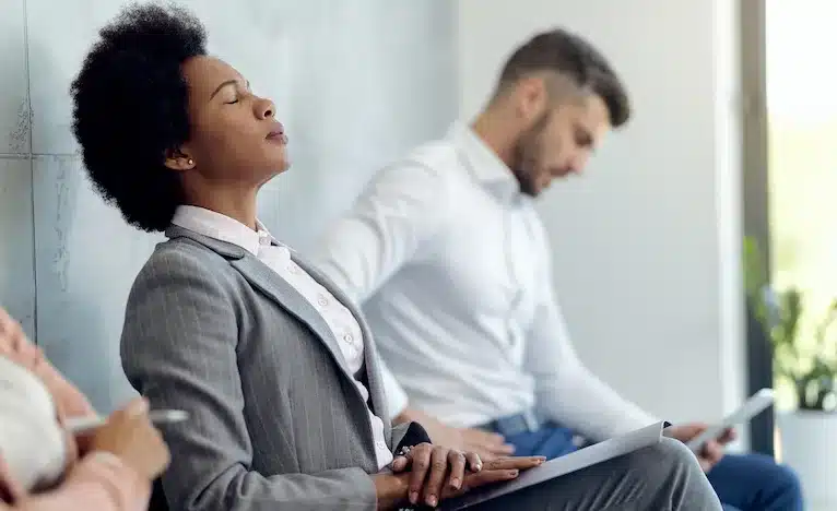 African American businesswoman trying to concentrate while waiting for a job interview.
