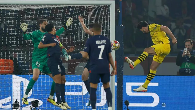 Hummels marca o gol do Borussia Dortmund sob os olhares de Mbappé / Foto: Andersen/AFP