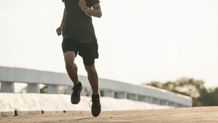 silhouette young fitness man running sunrise