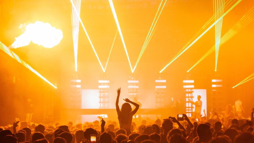 beautiful shot live concert performance with yellow light show big crowd cheering