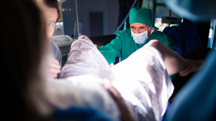 doctor examining pregnant woman delivery