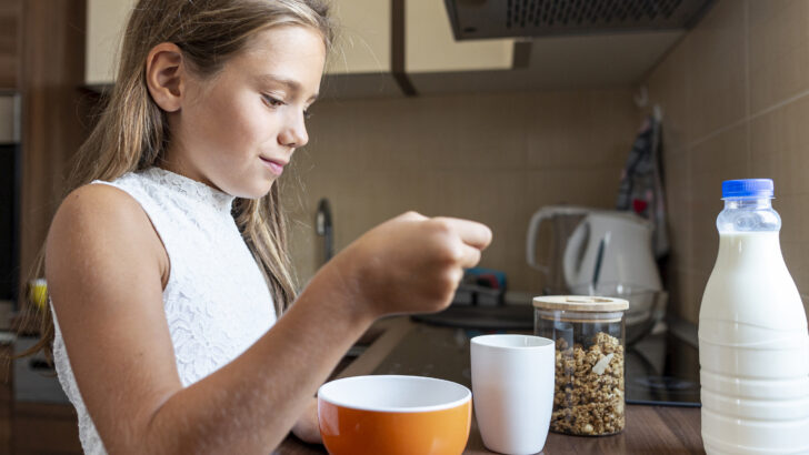 medium shot girl eating cereals