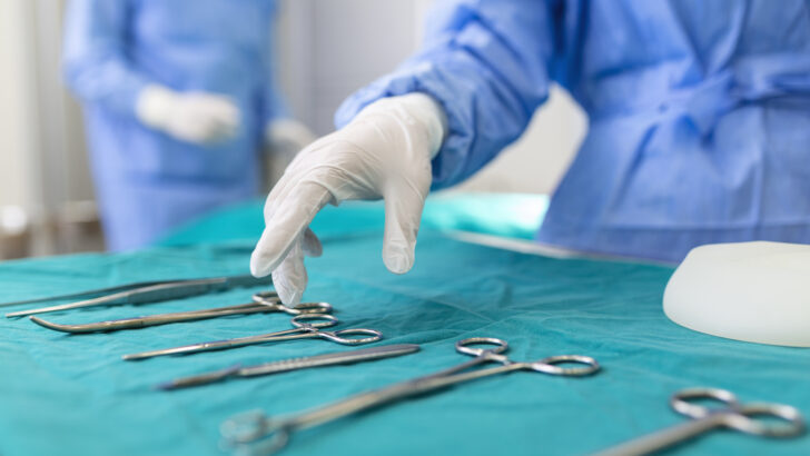 nurse hand taking surgical instrument group surgeons background operating patient surgical theatre steel medical instruments ready be used surgery emergency concept