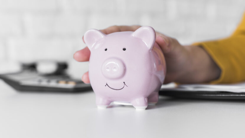 close up woman holding piggy bank Copia
