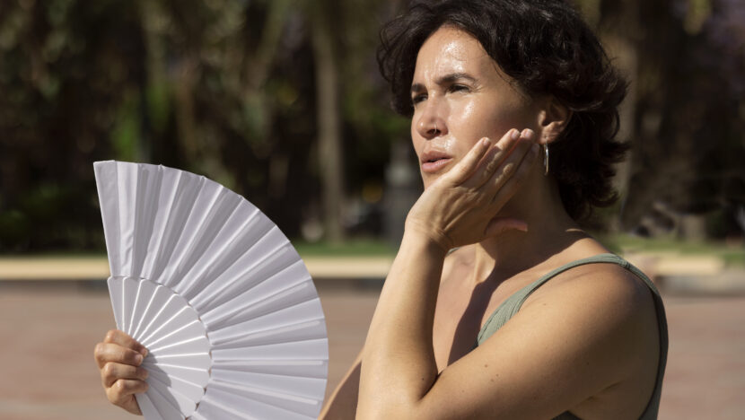elder woman struggling with high temperature Copia