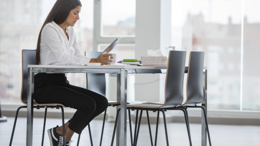 full shot woman sitting desk