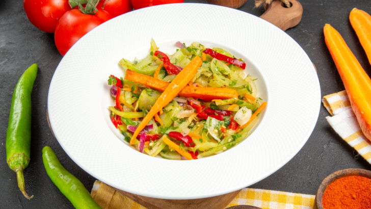 side close up view vegetables hot peppers spices tomatoes salad cutting board tablecloth Copia