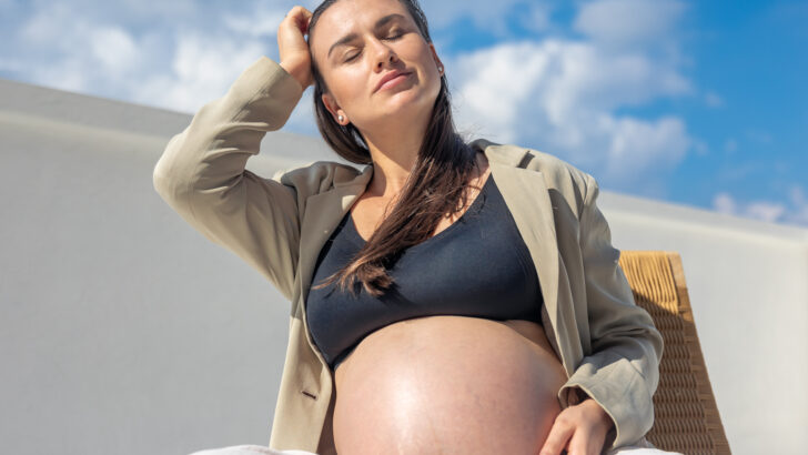 stylish pregnant woman beautiful wicker chair light background