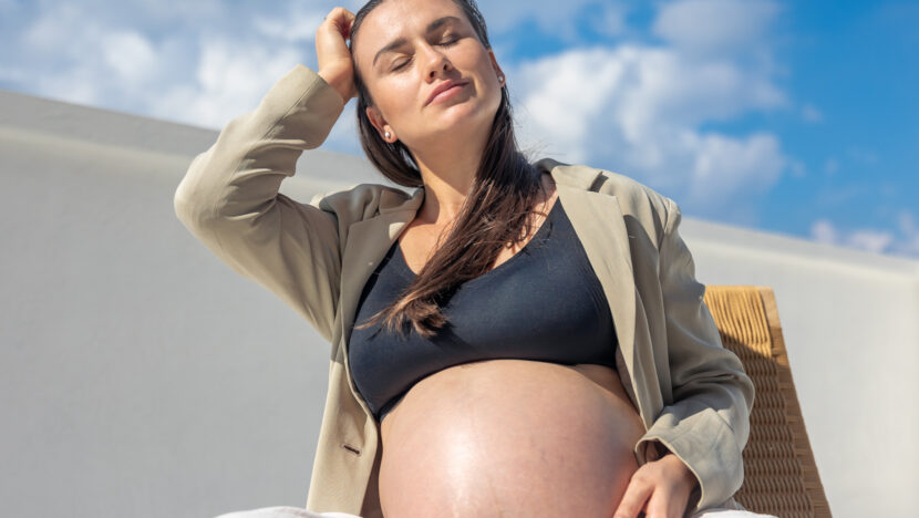 stylish pregnant woman beautiful wicker chair light background