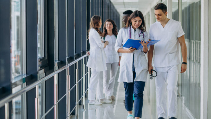 team young specialist doctors standing corridor hospital