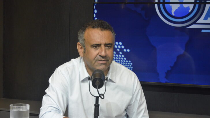 Babá Pereira sentado diante de um microfone durante entrevista em estúdio