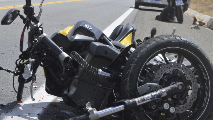 Motocicleta danificada caída sobre a pista após acidente de trânsito