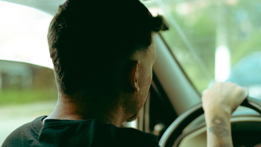 Motorista ao volante de um carro em área urbana no Brasil