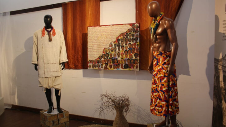 Manequins com figurinos e quadro com rostos pintados compõem a exposição no Memorial da Resistência