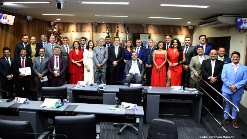 Vereadores de Natal posam em grupo no plenário da Câmara Municipal, atrás das bancadas, com bandeiras ao fundo