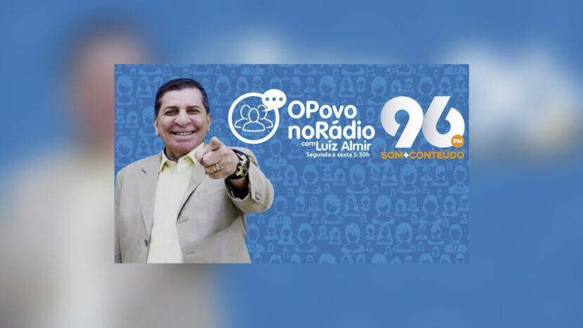 Luiz Almir diante do painel do programa O Povo no Rádio da 96 FM
